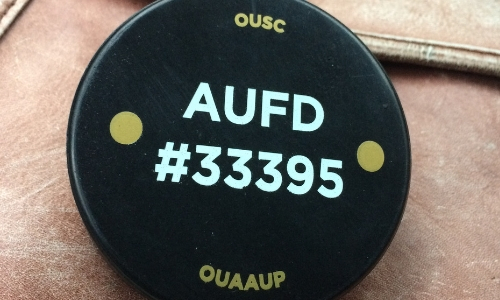 a hockey puck that was part of the Oakland University AAUP's fundraising campaign to provide classroom interior door lock