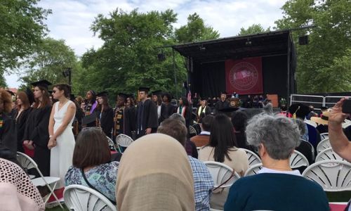 Graduating Oberlin College seniors at a June 2022 commencement ceremony turn their back on Oberlin Board of Trustees chair Chris Canavan to protest the college’s union-busting and austerity measures. Photo by Susie Kantt, whose daughter Abby Kantt spearheaded the protest