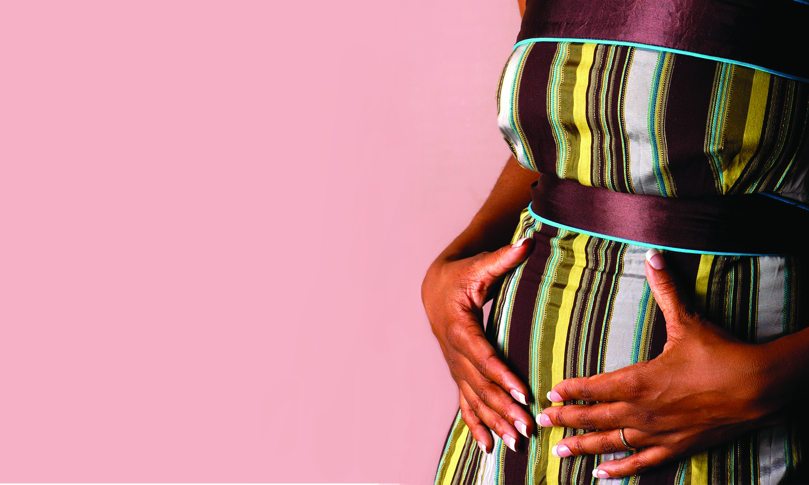 pink background with woman holding stomach