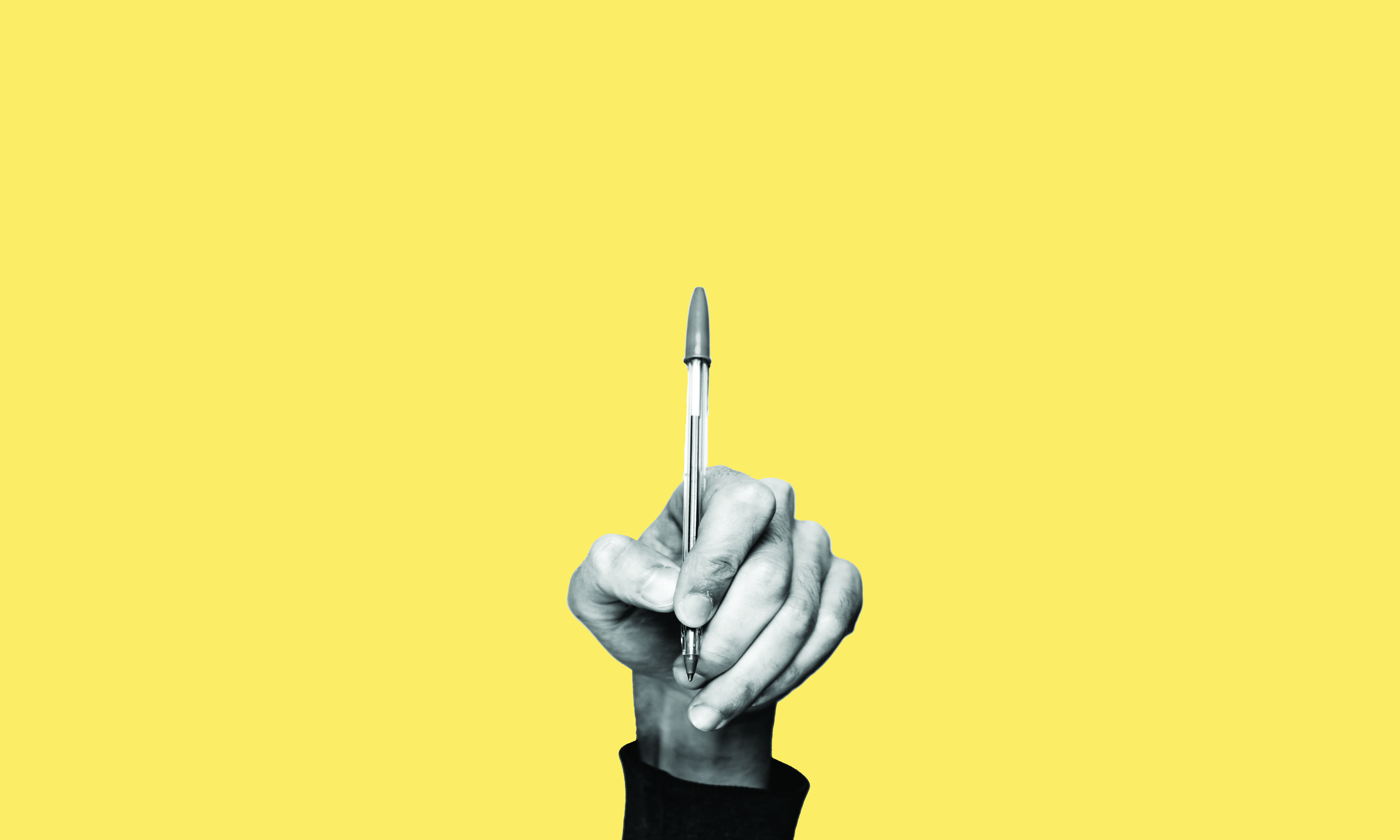 Yellow background with hand holding pen