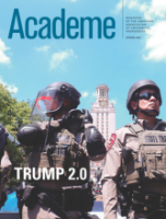 Two members of police in riot gear, one with a plastic visor over his helmet) stand in front of campus clock tower