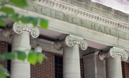 University building with columns and "SCIENCE HALL" engraved on it and the branches of a leafy tree in the left foreground