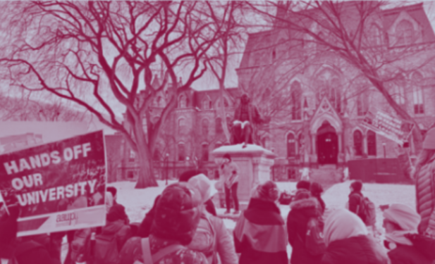 a group gathers in a snowy campus landscape facing a speaker; a sign on the left says "Hands Off Our University" with the AAUP Penn logo